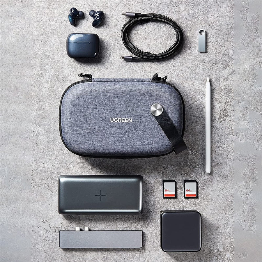 Flat lay of the organiser surrounded by earbuds, a cable, a flash drive, a stylus, a power bank, SD cards and a charger