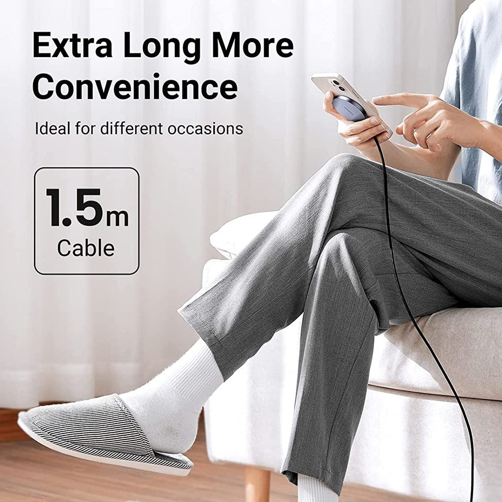 Someone using a phone on a sofa with the charger's 1.5 m cable reaching the floor, captioned extra long