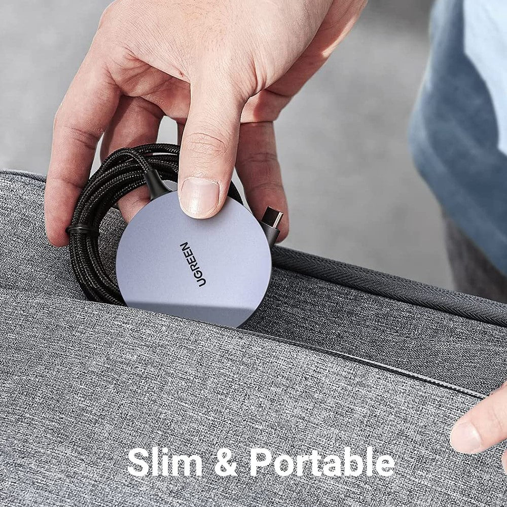 A hand tucking the slim charger and its coiled cable into a grey laptop sleeve, captioned slim and portable
