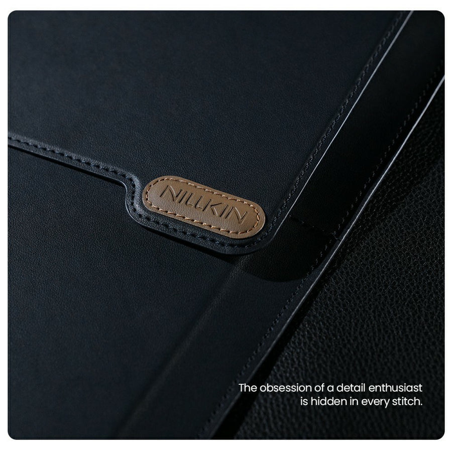 Macro shot of the tan Nillkin leather logo tab and stitched edge detail on the Dark Blue sleeve