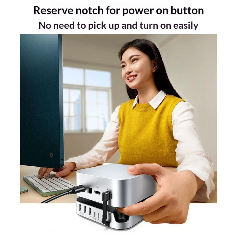A woman lifting a Mac mini with the dock attached, captioned a reserve notch for the power button