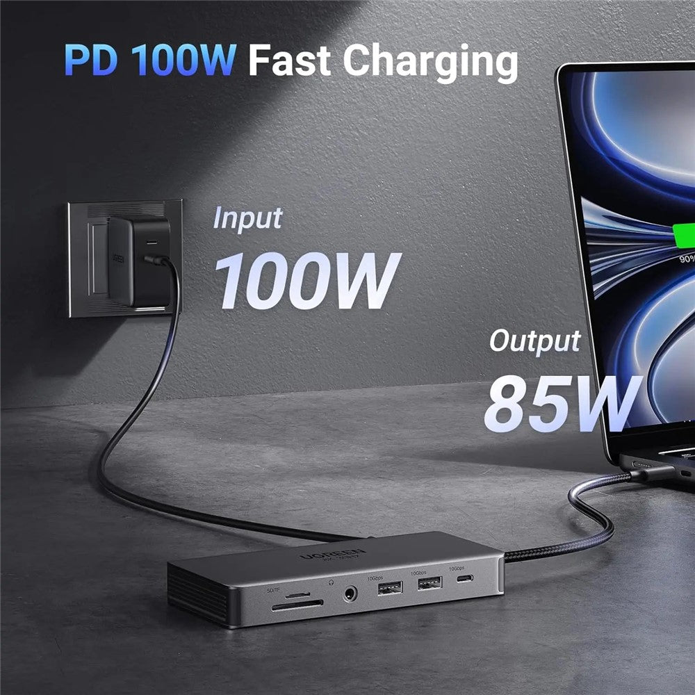 The dock charging a laptop from a wall socket, labelled 100W input and 85W output
