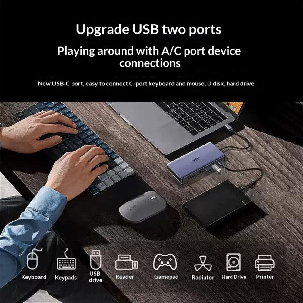 A person at a desk using a keyboard, mouse and external drive through the dock, with icons for keypads, USB drive, card reader, gamepad, cooler and printer