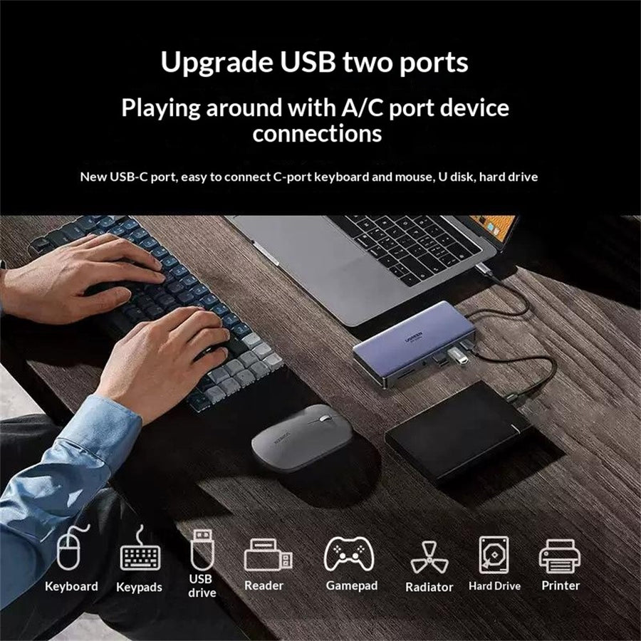 A person at a desk using a keyboard, mouse and external drive through the dock, with icons for keypads, USB drive, card reader, gamepad, cooler and printer