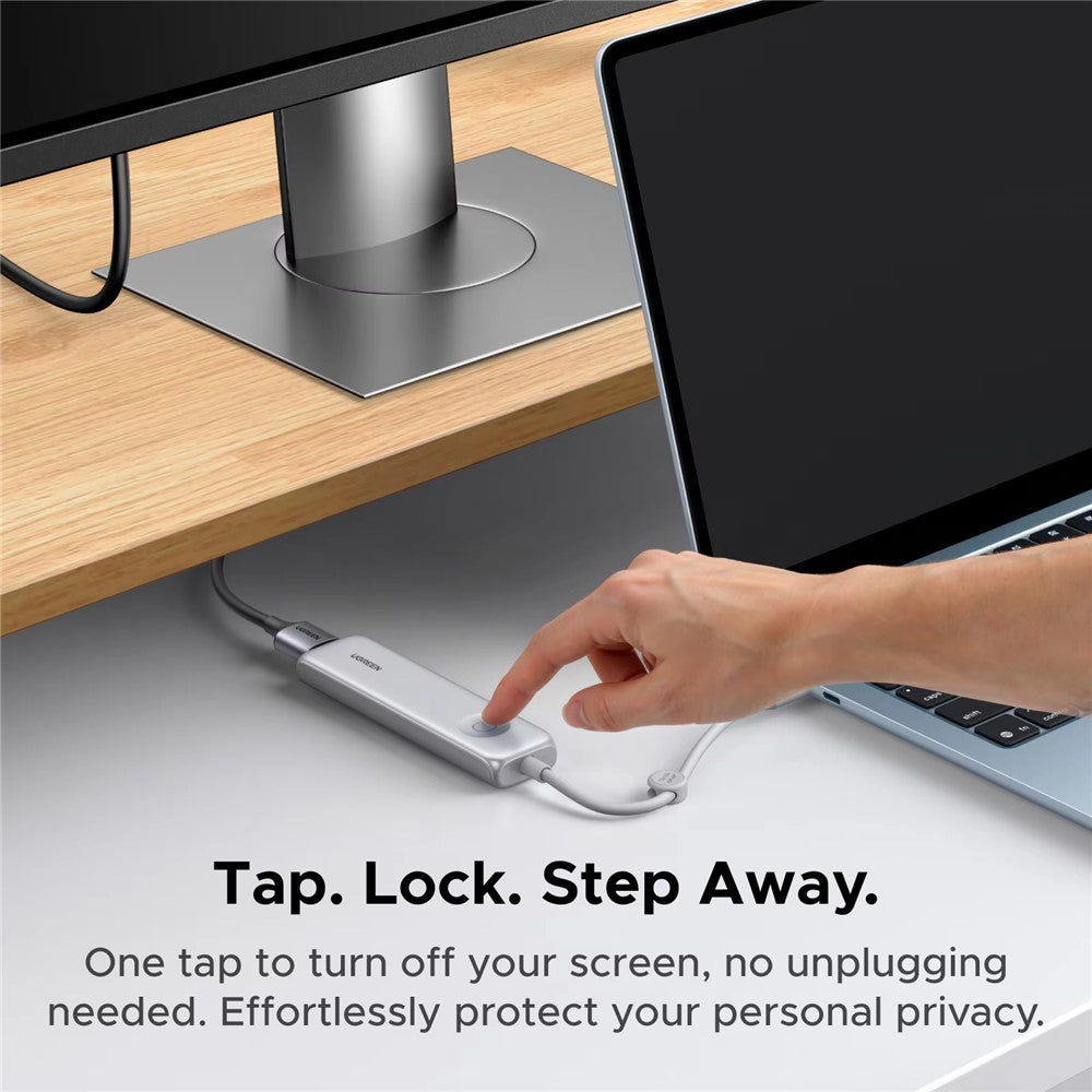 A hand pressing the hub's button under a desk with a laptop and monitor, captioned tap, lock, step away