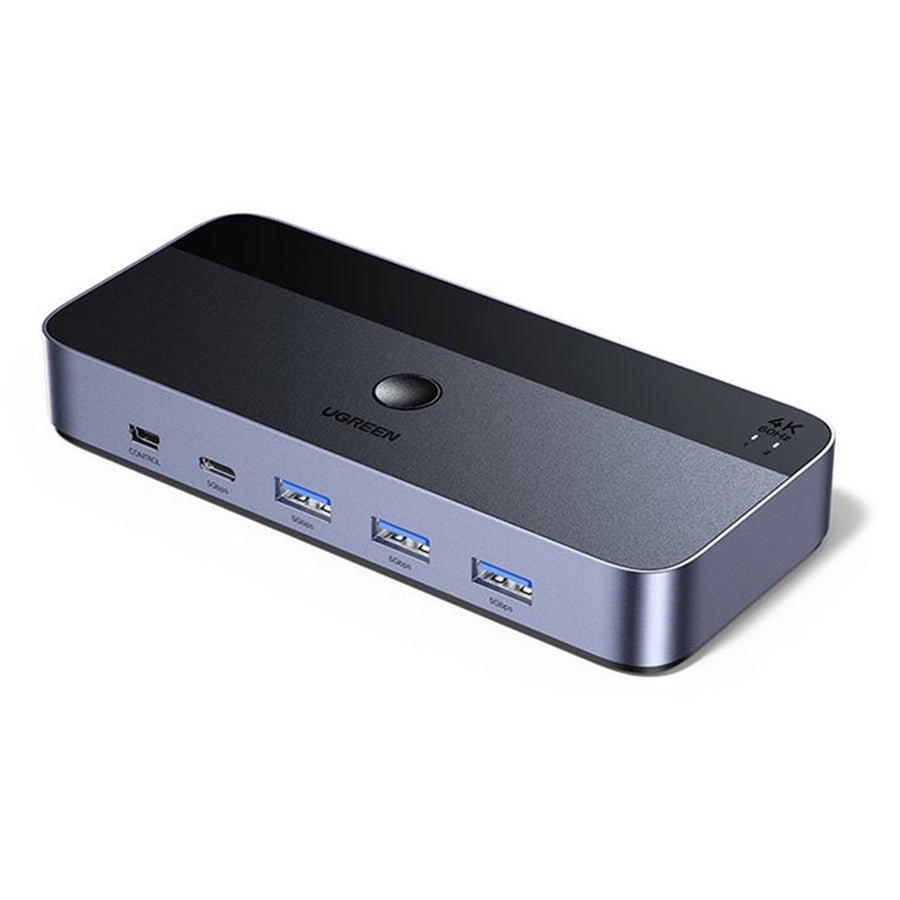UGREEN 35765 KVM switch in grey aluminium, angled to show the front selector button and its row of USB ports