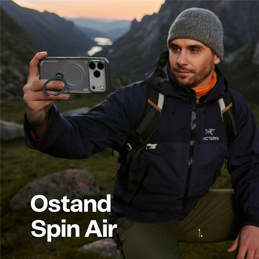 Man in outdoor setting holding a phone with 'Ostand Spin Air' case
