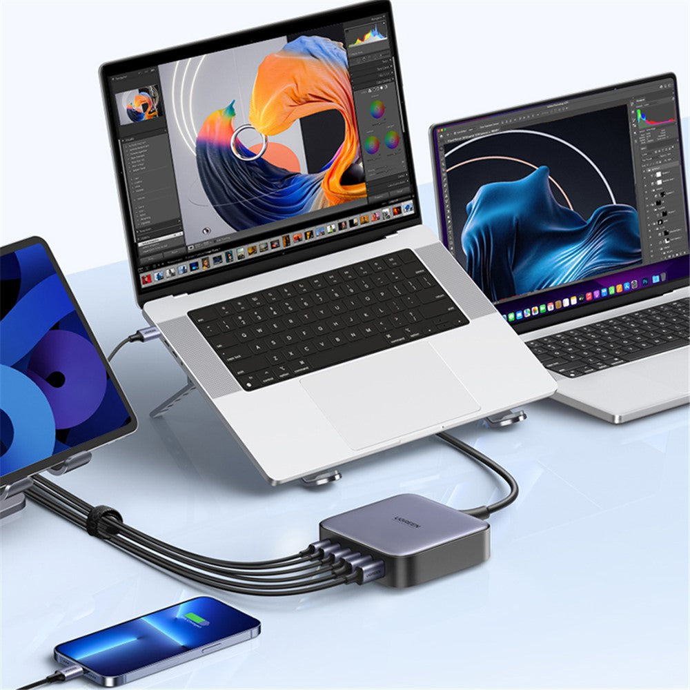 The charger running three laptops, a tablet and a phone from one socket