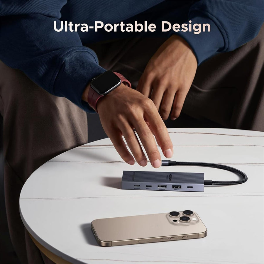 A person setting the compact hub down on a round table beside a phone, captioned ultra-portable design