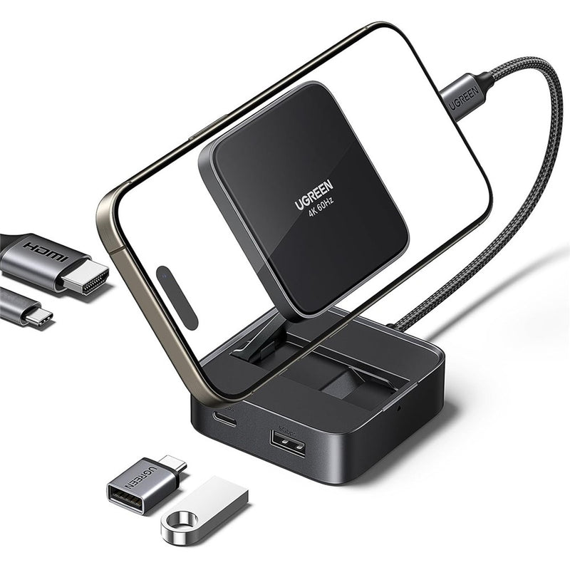 UGREEN 4-in-1 magnetic folding hub holding a phone upright, shown with USB-C and USB-A adapters beside it