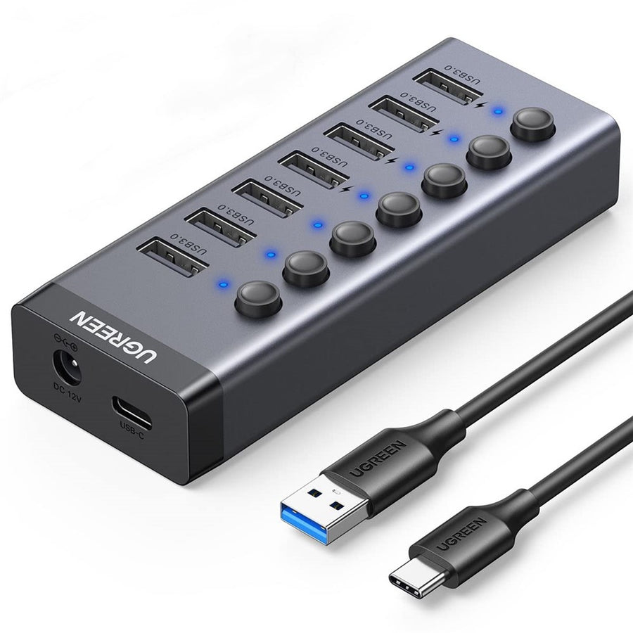UGREEN CM481 seven-port USB 3.0 hub in grey aluminium with its blue port LEDs lit and its data cable attached