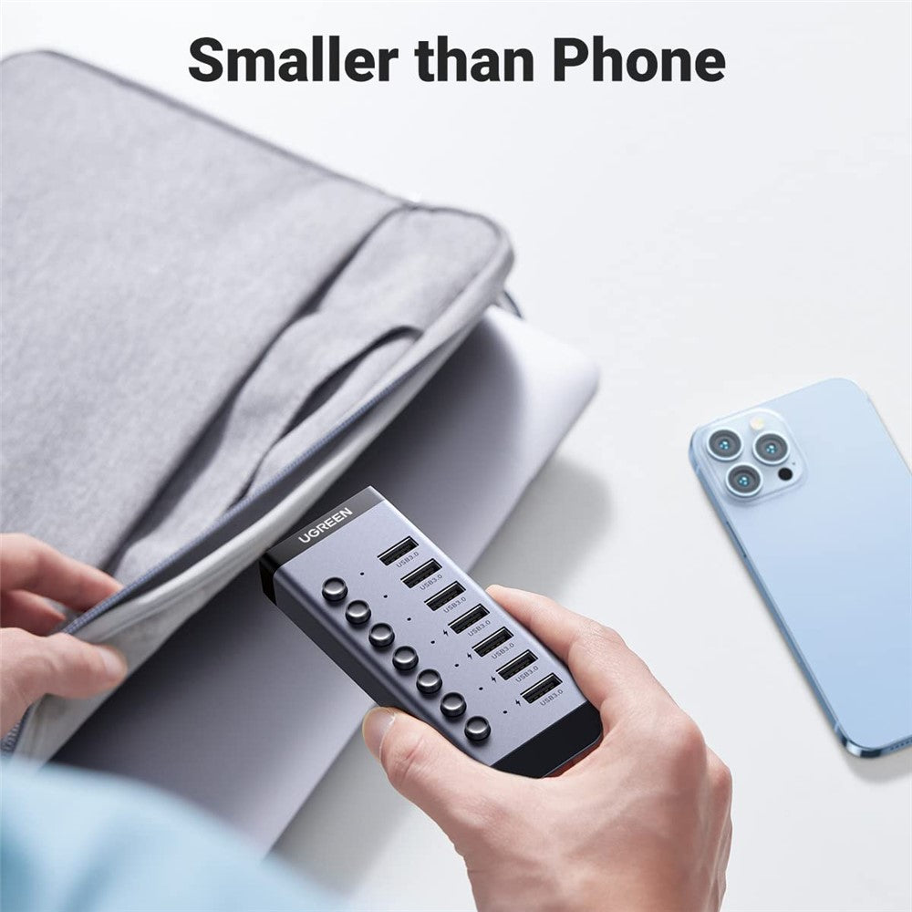 A hand holding the hub next to a phone for scale, captioned smaller than phone
