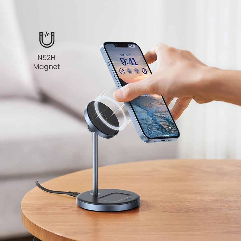 A hand pulling an iPhone from the stand on a wooden table, captioned N52H magnet