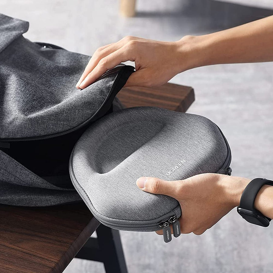 A person lifting the closed case out of a backpack